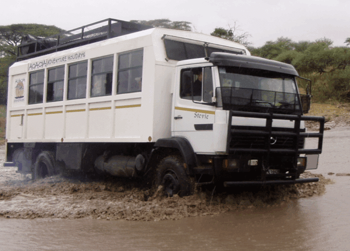 Jono Wilson driving Stevie the truck overloading in Africa with Acacia.